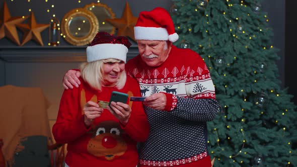 Senior Family Grandmother Grandmother Using Credit Bank Card and Smartphone Shopping Christmas Gifts