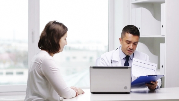 Smiling Doctor And Young Woman Meeting At Hospital