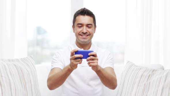 Happy Man With Smartphone At Home