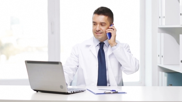 Happy Doctor With Laptop Calling On Smartphone
