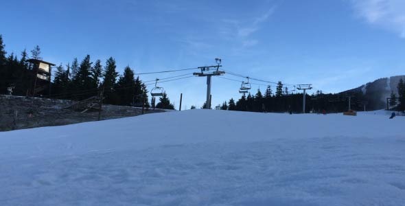 Ski and Snow Boarders Riding Down the Mountain