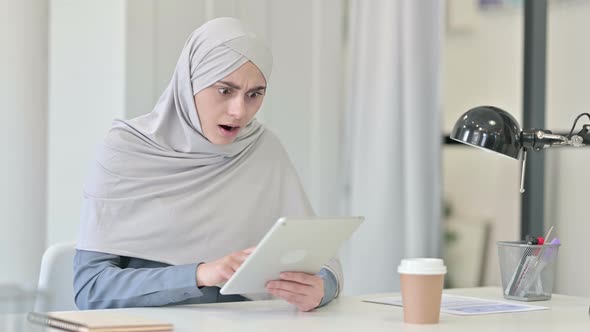 Young Arab Woman Reacting to Loss on Tablet