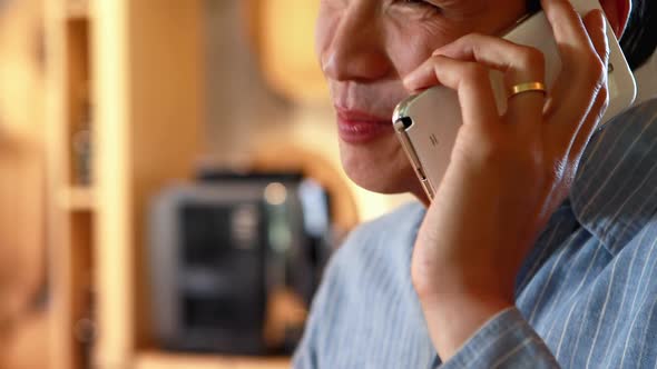 Man having beer while talking on mobile phone in a restaurant 4k