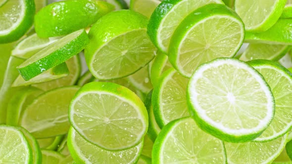 Super Slow Motion Shot of Flying Fresh Lime Slices Towards Camera at 1000Fps