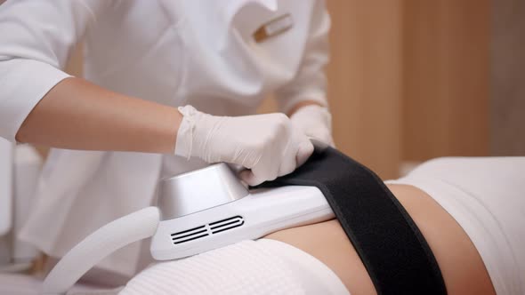 Woman Makes Treatment Nurse Makes Adjustments and Fixing the Machine on the Body of Patient