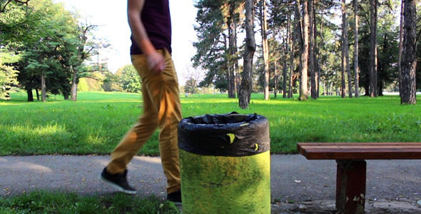 Man Throwing Paper In Trash Can