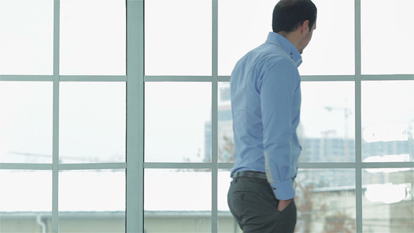 Businessman In Formal Wear Looks At His Watch alt