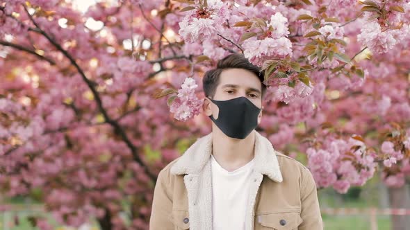 Portrait of Young Handsome Man Wearing Black Medicine Mask. Healthy Lifestyle Concept.