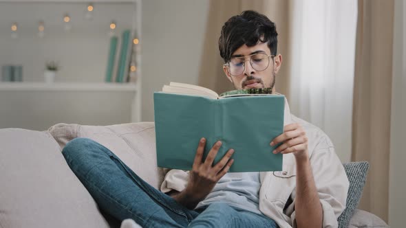 Young Guy Student Smart Concentrated Arabic Hispanic Man Male Arab Wears Eyeglasses Lying Sitting on