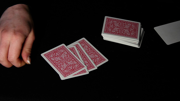 Woman Hand Shuffle Poker Cards On Black Background