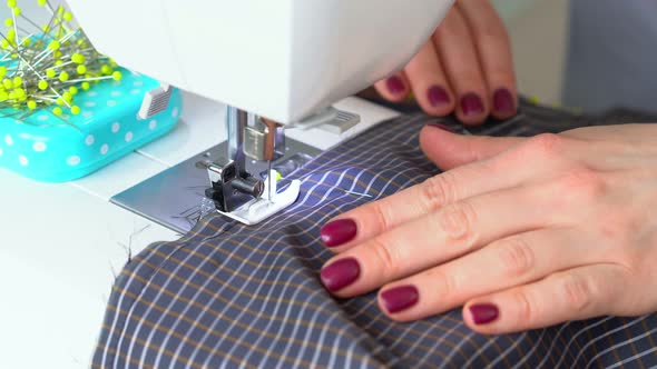 Seamstress Woman Works on Sewing Machine