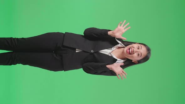 Asian Business Woman Showing Gesture Hands Palm Saying Wow And Smiling In The Green Screen Studio