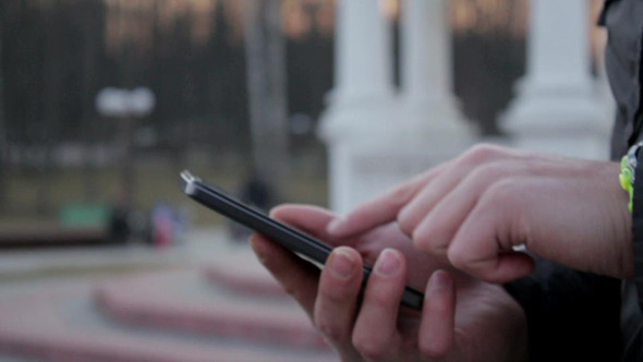 Man Using Smartphone in Park