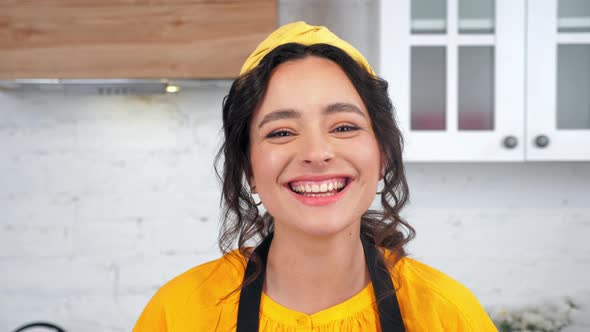 Close Up Smiling Housewife Turns Head Looking Camera in Home Modern Kitchen