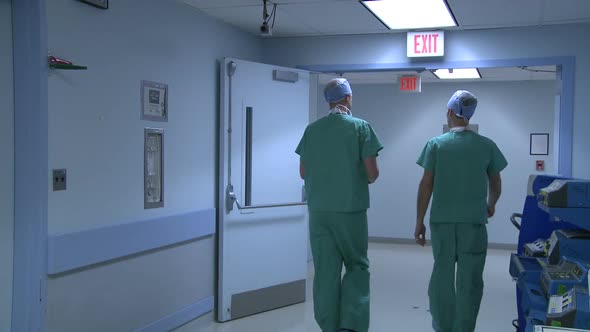 Doctors Converse As They Walk Through Hallway (2 Of 3)