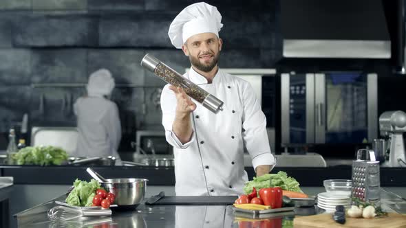 Smiling Chef Playing with Pepperbox at Workplace