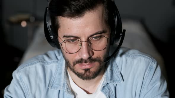 Young business man using laptop video conference talking to colleagues meeting online