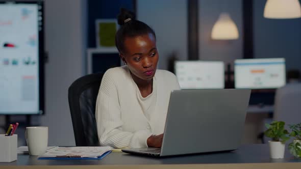 Stressed African Businesswoman Suffering From Headache at Work