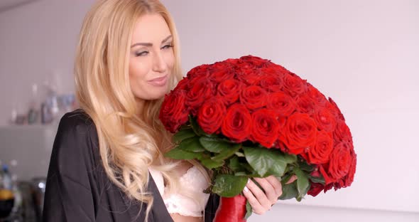 Smiling Woman In Sleepwear Holding A Rose Bouquet 1