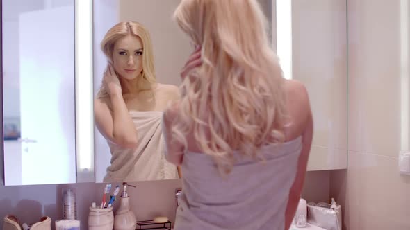 Woman Looking At Herself On The Bathroom Mirror 2 alt