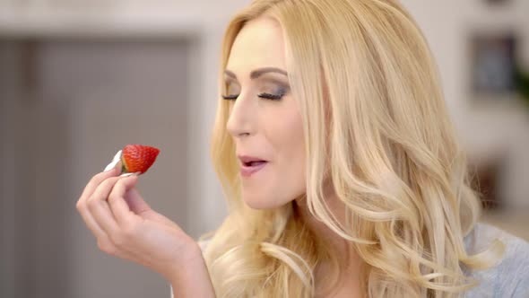 Healthy Attractive Blond Woman Eating A Strawberry 2