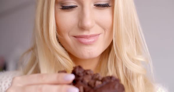 Female Hand Holding A Piece Of Chocolate Cupcake 1