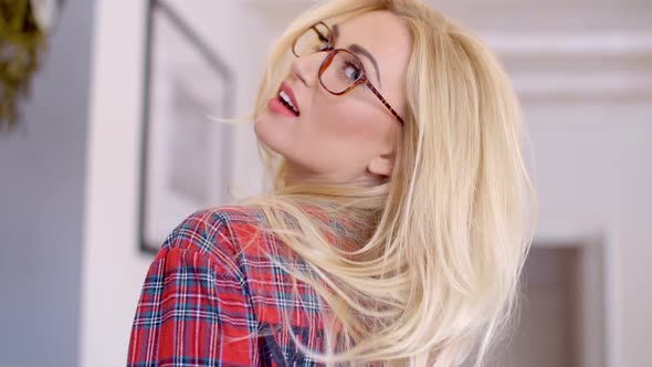 Young Blond Woman With Glasses Looking At Camera alt