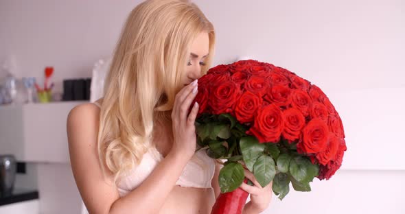 Sexy Woman In White Bra Holding A Rose Bouquet 1