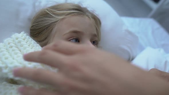 Cute Female Child in Scarf Coughing in Bed, Caring Mother Touching Kids Forehead