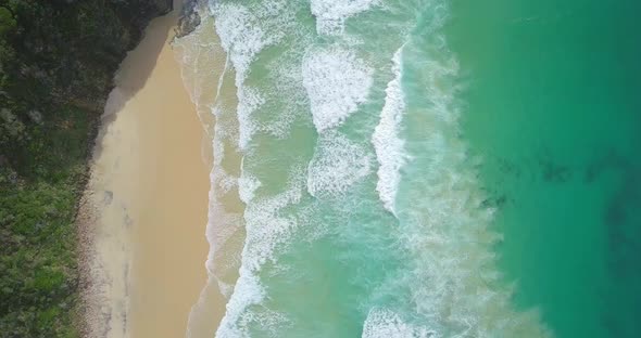 Stunning aerial flight over strong waves and isolated lonely beach, Australia