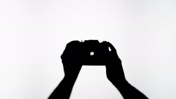 Shadow of Photo Camera on White Background