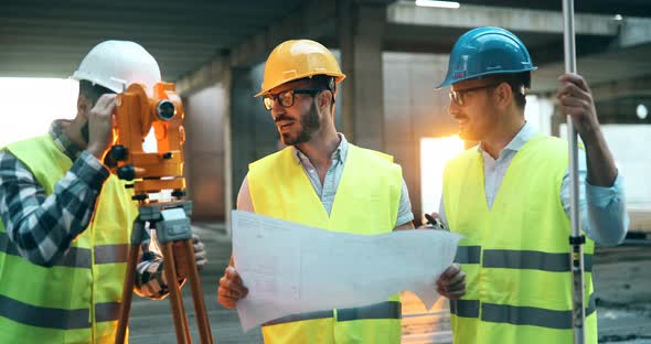 Portrait of Construction Engineers Working on Building Site