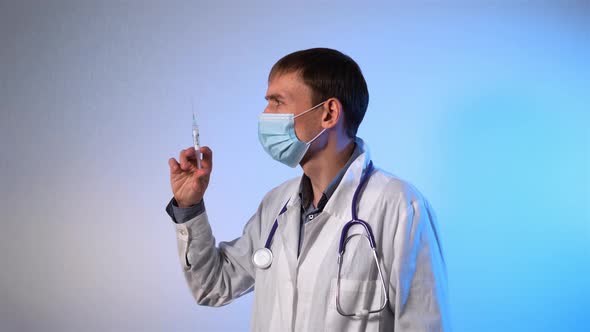 Male Doctor Holds Syringe COVID Vaccine