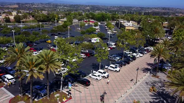 Aerial fly through of a shopping mall strip mall parking lot shot1