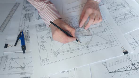 Architect Checks the Construction Drawing