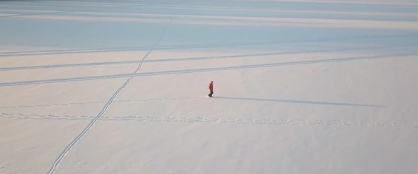 Man Walking On The Icy Lake