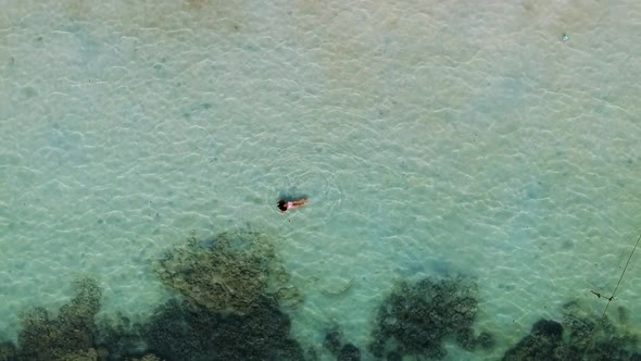 Aerial shot of girl swimming at Sairee Beach Koh Tao, Thailand