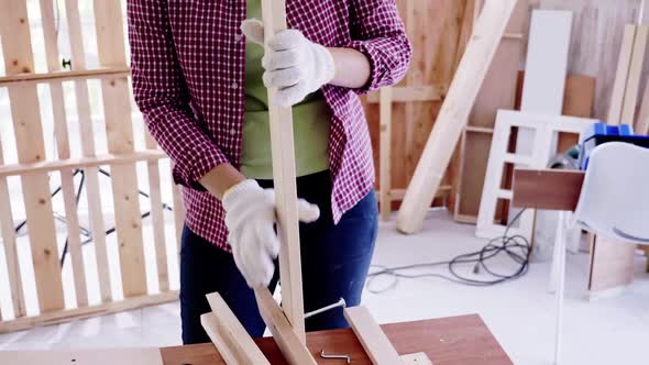 Stylish craftswoman working in carpentry. Woodwork and furniture making concept.