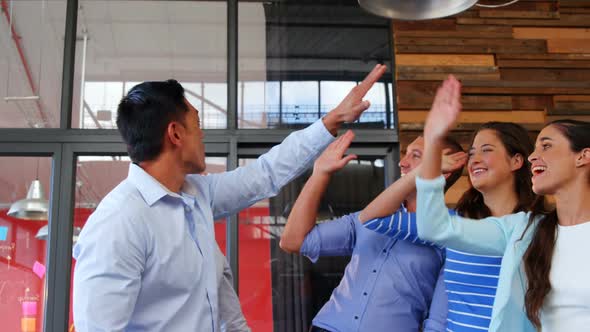 Group of happy business executives giving high five