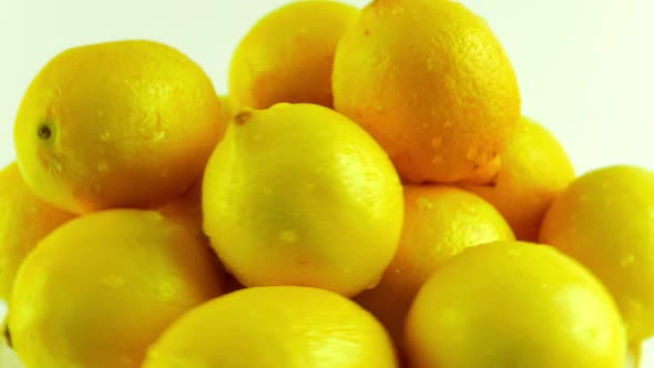 A Group of Fresh Lemons Rotating Against a White Background