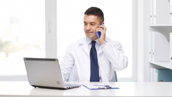Happy Doctor With Laptop Calling On Phone