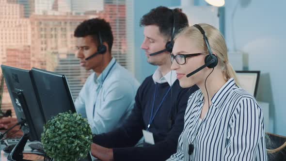 Medium Shot of Female Customer Service Working in Busy Call Center By Talking to the International