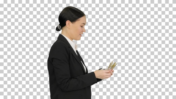 Happy business woman counting money while walking, Alpha Channel
