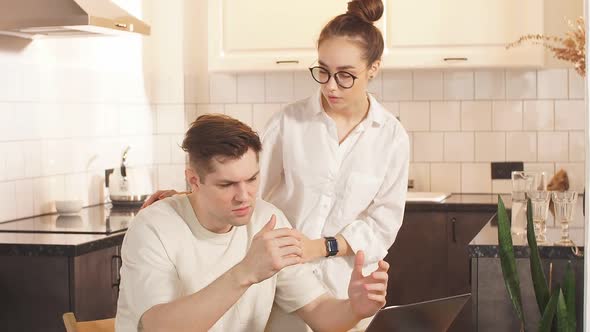 Married Couple Use Their Own Laptop for Developing Business They are at Freelance