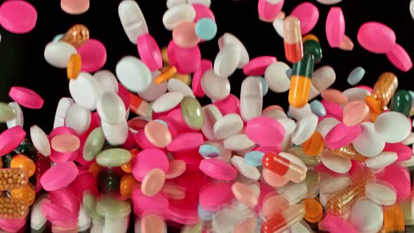 Super Slow Motion Shot of Falling Colorful Pills on Black Background at 1000Fps.