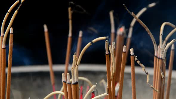 Incense Sticks Burning In Giant Pot In Front Of Buddhist Temple