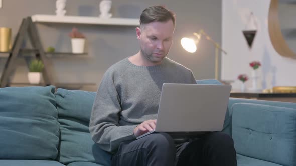 Casual Man Closing Laptop and Leaving Sofa