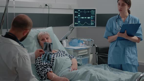 Doctor Pointing at x Ray Scan for Consultation with Sick Patient