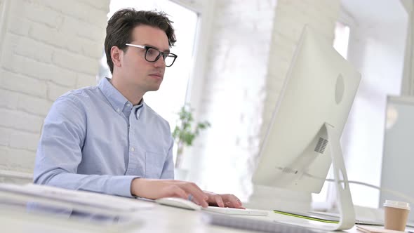 Surprised Working Young Man Feeling Shocked in Office