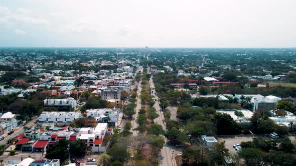 Drone view of Merida Avenue in mexico with railroad at the middle